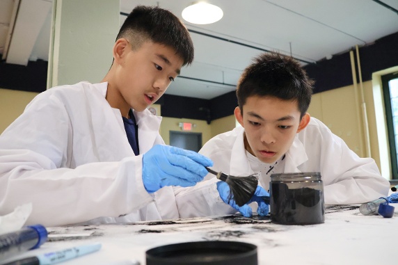 Two boys doing fingerprint analysis